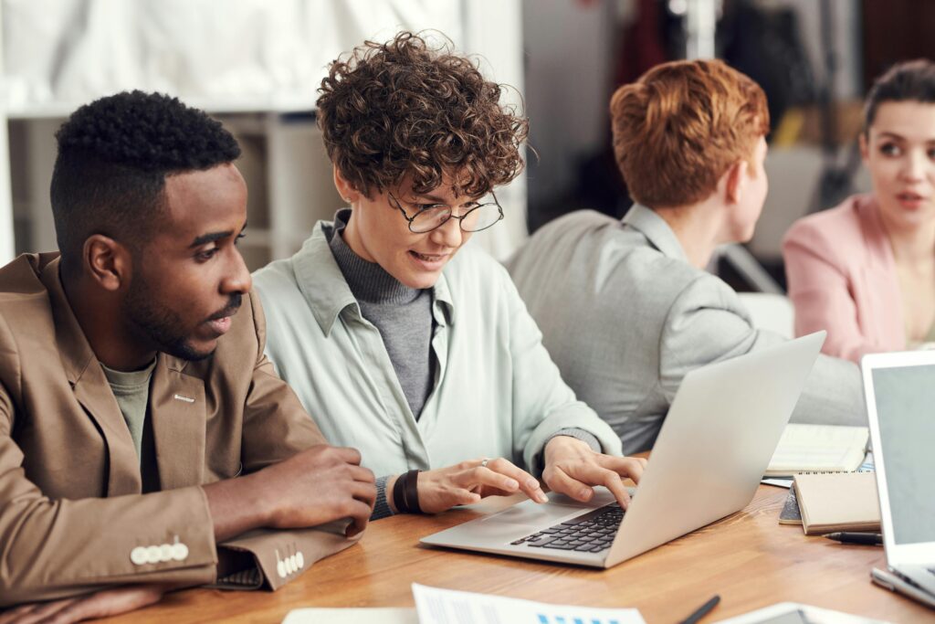 Two colleagues working together on a laptop