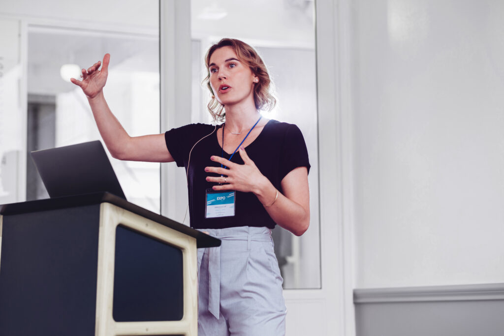 Businesswoman speaking from a podium in a seminar.