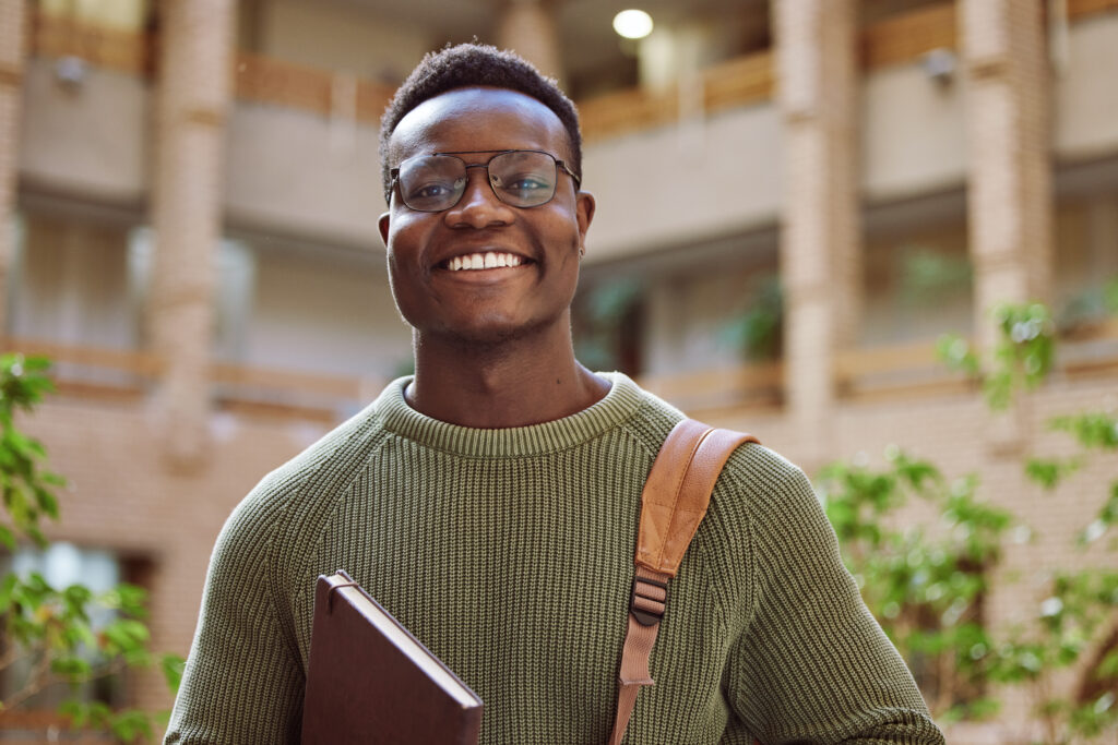College student looking happily into the camera